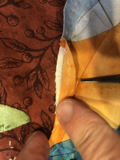 Figure 11 Edge of applique piece showing basting stitches